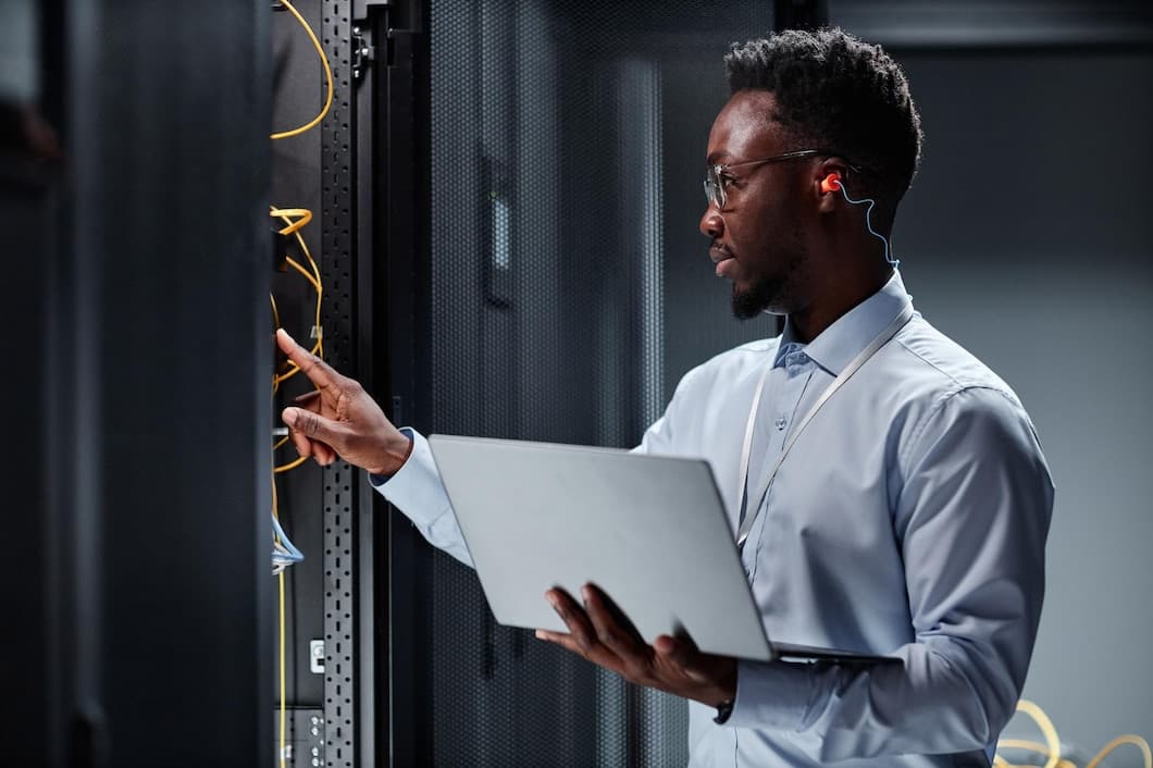 A Verbosec engineer working with a laptop in a server room